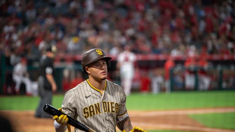 Manny Machado in San Diego Padres uniform during a game, focused expression at the plate