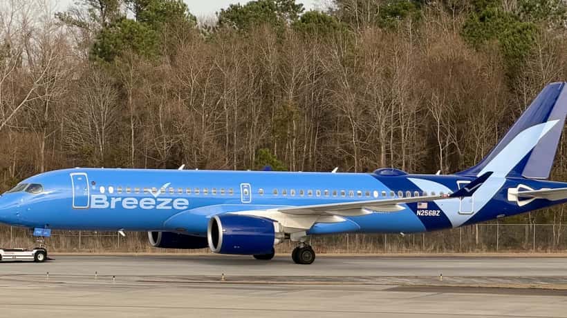 Avión Airbus A220-300 de Breeze Airways en vuelo, representando los derechos de pasajeros en aerolíneas de bajo costo 2026