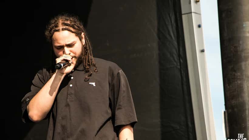 Post Malone performing live at a stadium concert