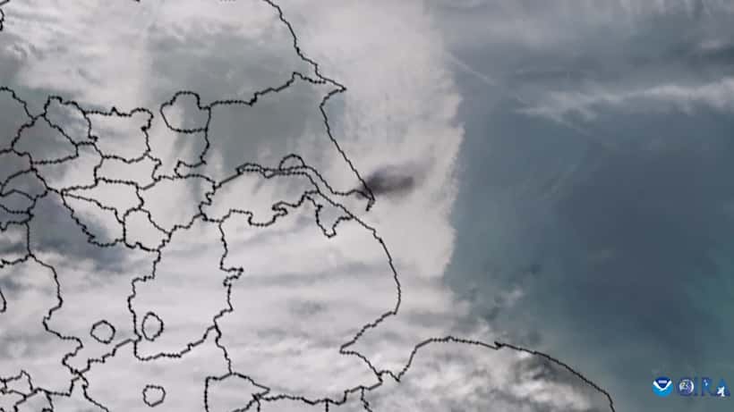 Black smoke plumes rising from ship collision at sea — illustrating maritime disaster risk for commercial shipping