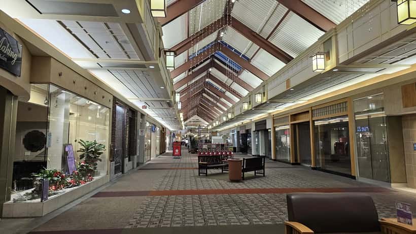 Interior corridor of a US shopping mall with stores and visitors
