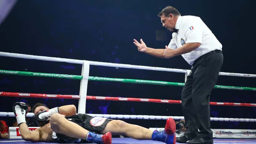 Combat sports knockout moment representing brain injury risk in mixed martial arts