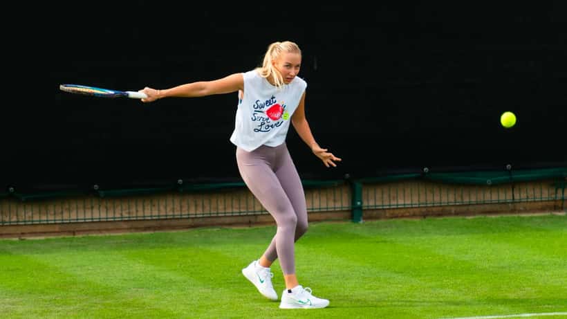 Anastasia Potapova competing on clay court at tennis tournament