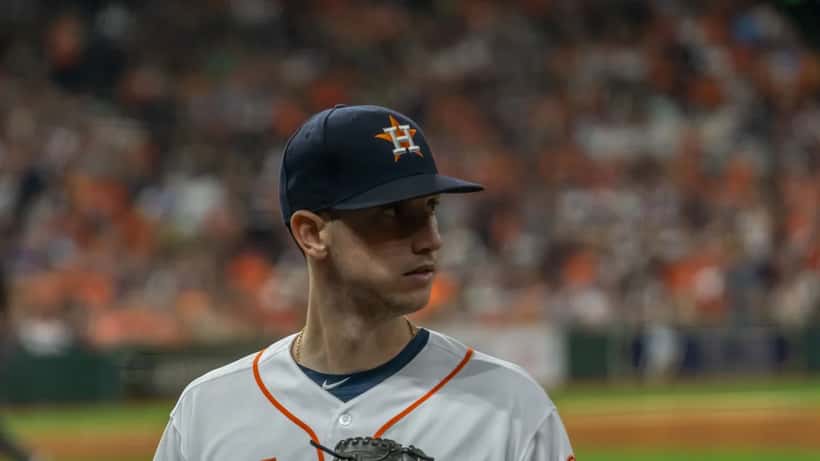Kyle Tucker in baseball uniform preparing to bat, stadium crowd in background
