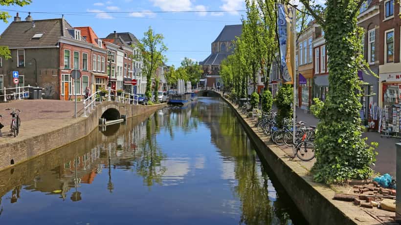 Gracht in Delft met historische gevels weerspiegeld in het water