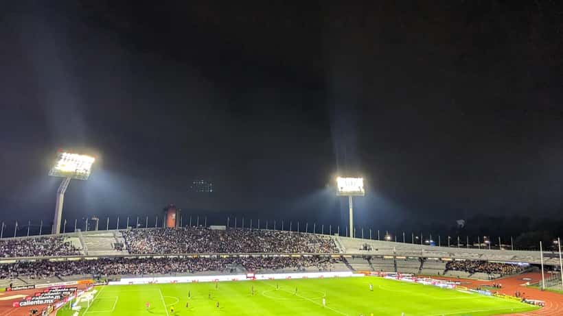 Tigres UANL players competing against Pumas UNAM in a Liga MX match