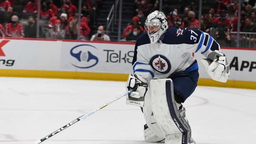 Connor Hellebuyck in goal during Winnipeg Jets game at Washington Capitals arena
