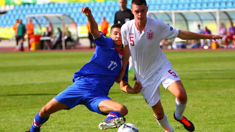 Croatian and English players competing for the ball during an international football match