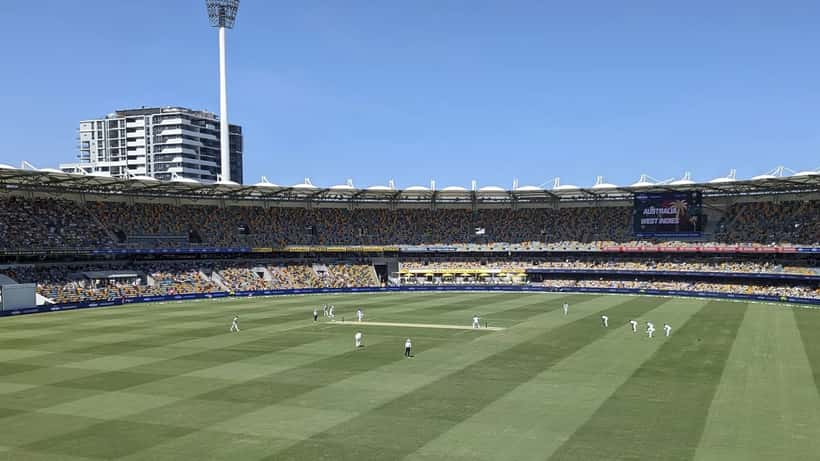 West Indies cricket player bowling during a match, action shot at a cricket stadium