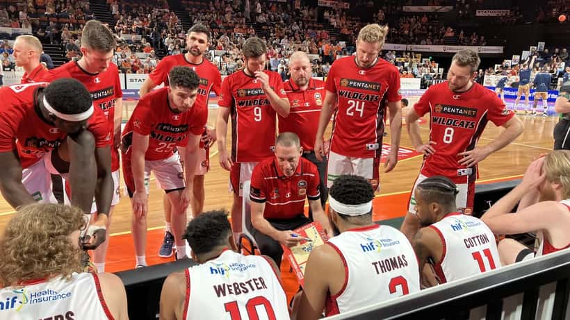 Perth Wildcats players on the basketball court at RAC Arena during an NBL game