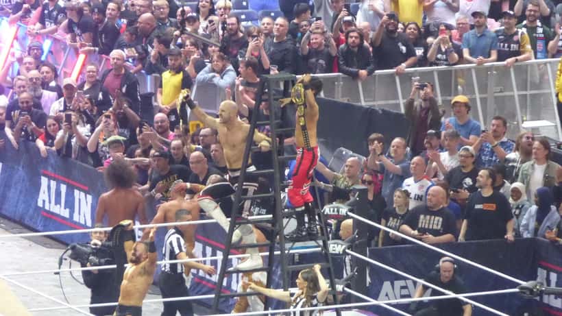 PAC, Claudio Castagnoli and Wheeler Yuta posing as AEW World Trios Champions on stage
