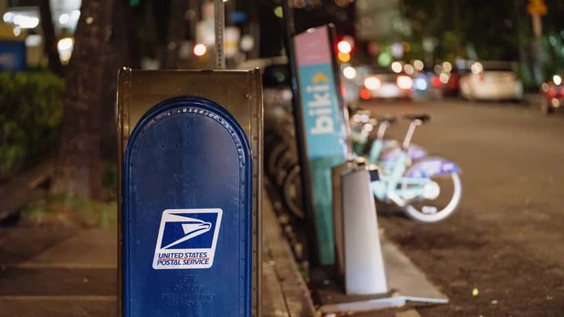 USPS blue mail collection drop box on a street corner in Hawaii