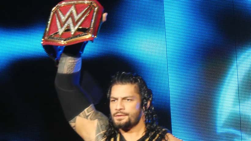 Roman Reigns WWE champion standing in the ring after retaining the World Heavyweight title