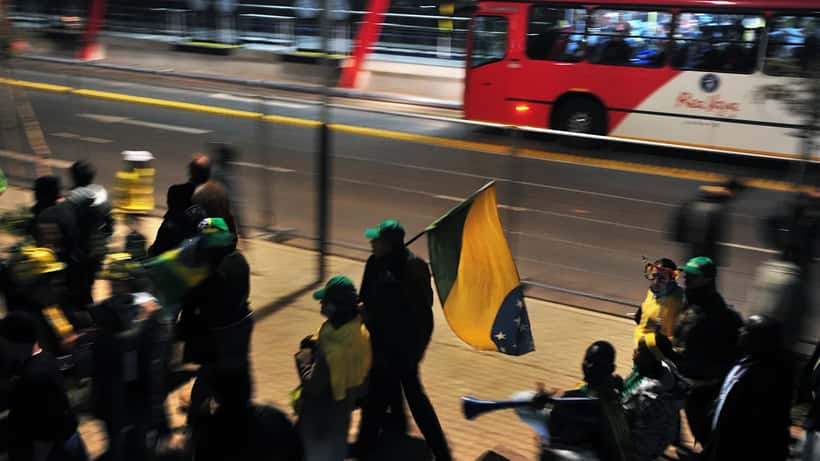 Brazilian soccer fans in yellow jerseys arriving at a World Cup stadium