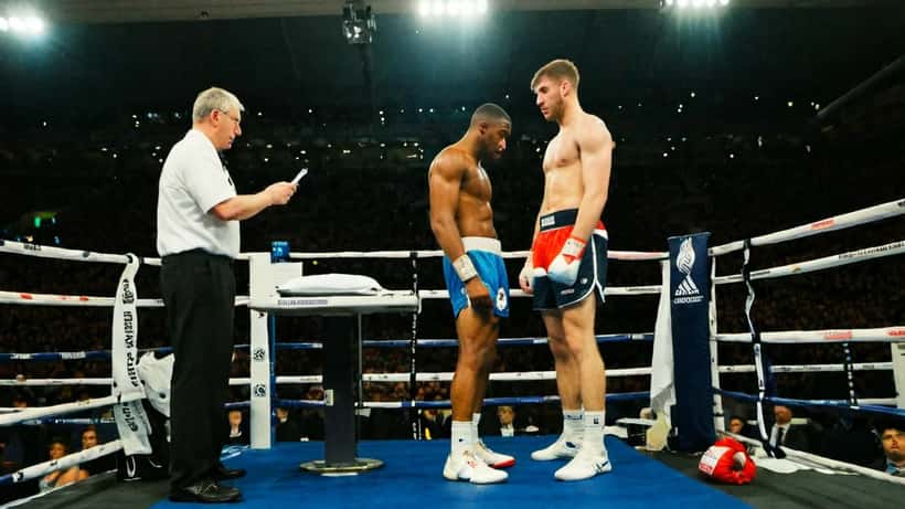 Professional boxer standing on scale at weigh-in with athletic commission official and ringside doctor present