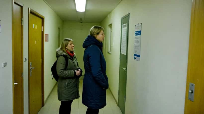 Norsk lærer og forelder i samtale utenfor klasserom i Oslo-skole, bekymret over skolemiljø og vold 2026