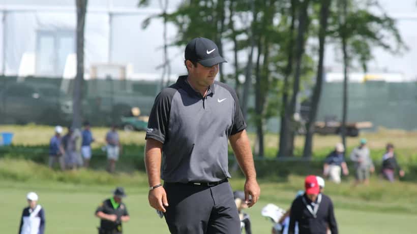 Patrick Reed at a golf tournament, preparing to swing