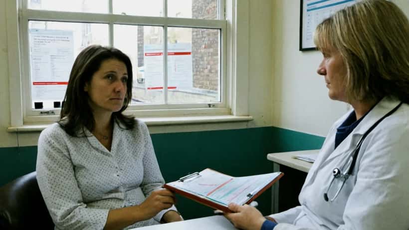 Woman in a medical consultation discussing hormonal health and fertility options with a specialist in a London clinic