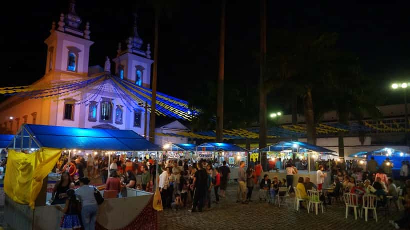 Celebração de festa junina com fogueira e pessoas em trajes típicos no Brasil
