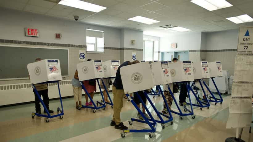 Voters casting ballots at a primary election polling station
