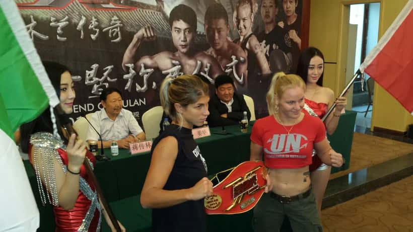 Valentina Shevchenko in a combat sports bout, raising her arm in the ring