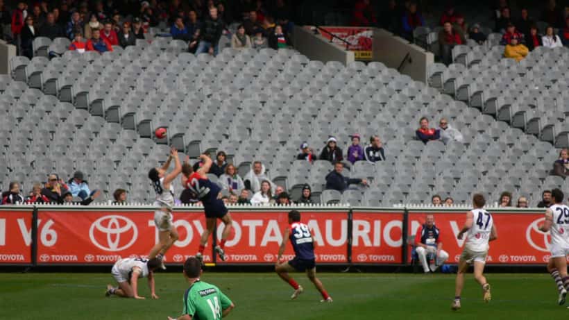 AFL marking contest between Melbourne and Fremantle players during a Premiership match