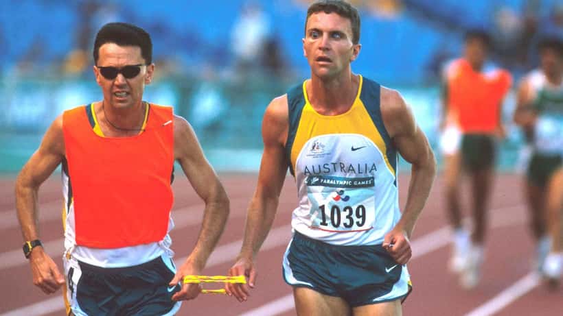 Australian sprinter racing on an athletics track, Sydney 2000 Olympics