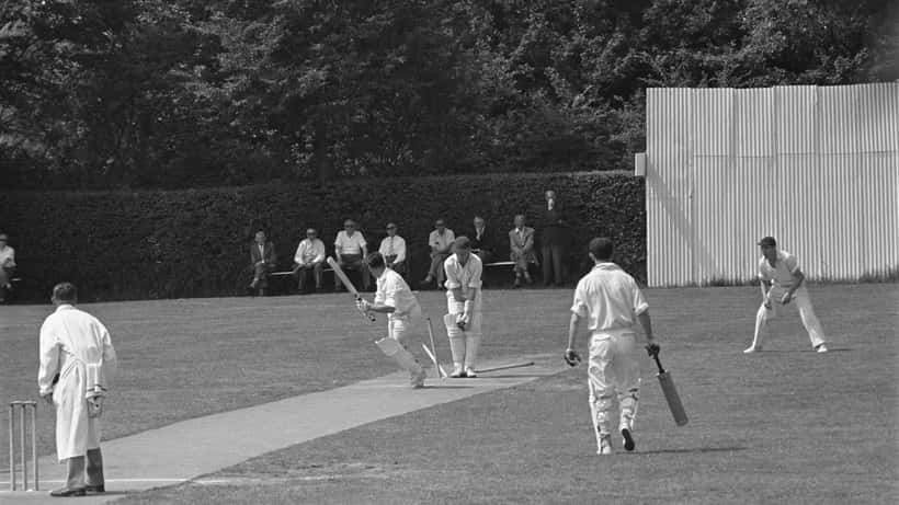 Dutch cricket players competing in a Netherlands club match at an outdoor ground