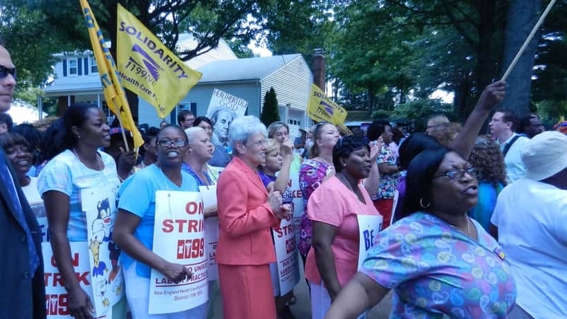 Workers on a picket line holding signs during a public sector strike in Canada