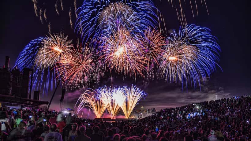 Fireworks bursting over Seattle Lake Union at night during the Seafair Fourth of July celebration