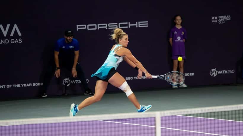 Tenistas jogando partida de duplas no WTA Transylvania Open em quadra de saibro