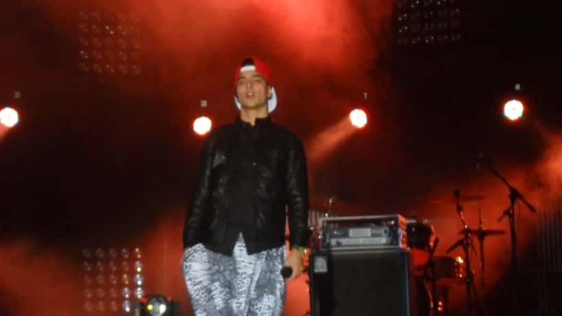 Maluma performing live on stage at a concert
