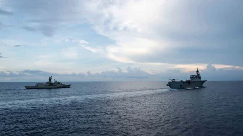 Japanese Maritime Self-Defense Force warship sailing alongside Royal Australian Navy frigate, symbolising the AU-Japan defence partnership