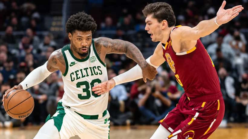 Marcus Smart playing basketball, defensive stance in NBA game action