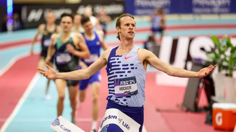 Elite 1500m runner in mid-stride on an indoor athletics track, representing competitive middle-distance running in Australia 2026
