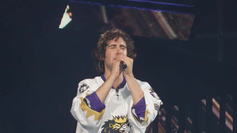 Josh Groban performing live on stage at an arena concert