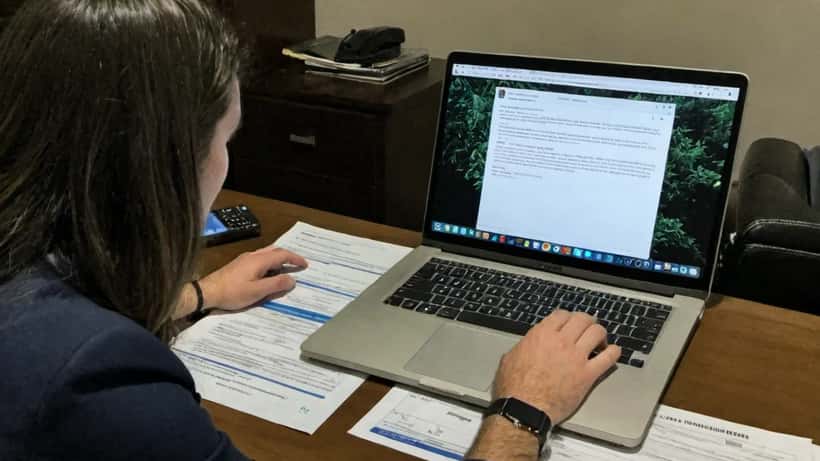 Attorney reviewing viral social media accusations and legal documents on laptop screen