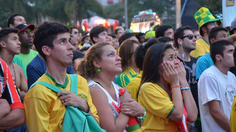 Football fans watching a tense World Cup match together at night