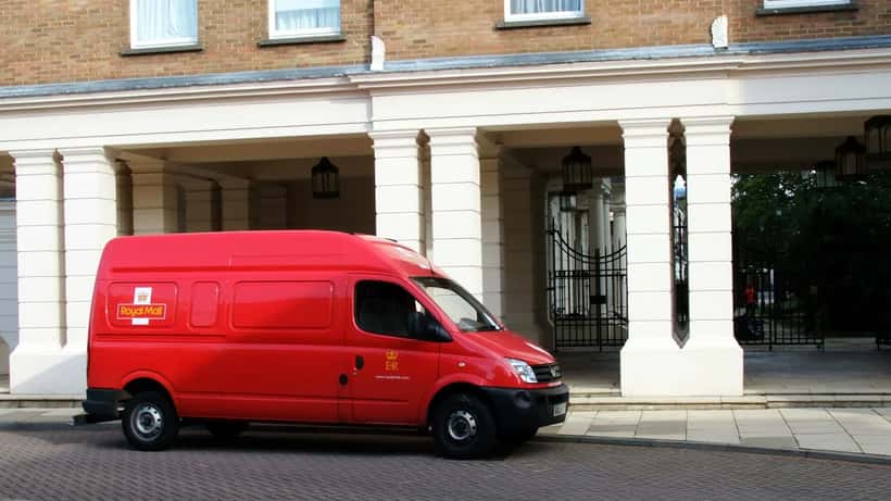 Red Royal Mail delivery van parked on a residential street in Pimlico, London