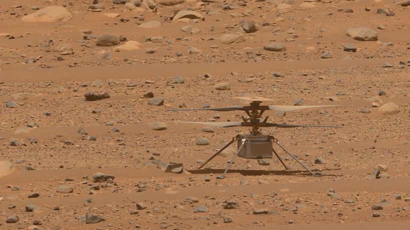 NASA Perseverance rover and Ingenuity helicopter on the dusty red Martian surface