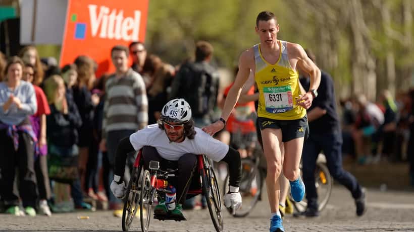 Löpare i Paris Marathon passerar förbi på en stadsgata under tävlingen