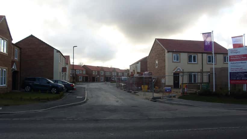 New residential housing development in the UK — row of newly built homes under grey sky