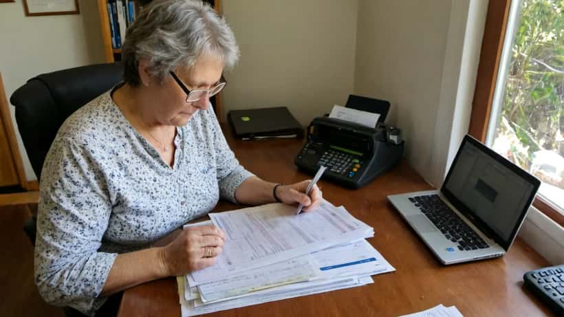 Australian woman reviewing cross-border estate planning documents in a home office