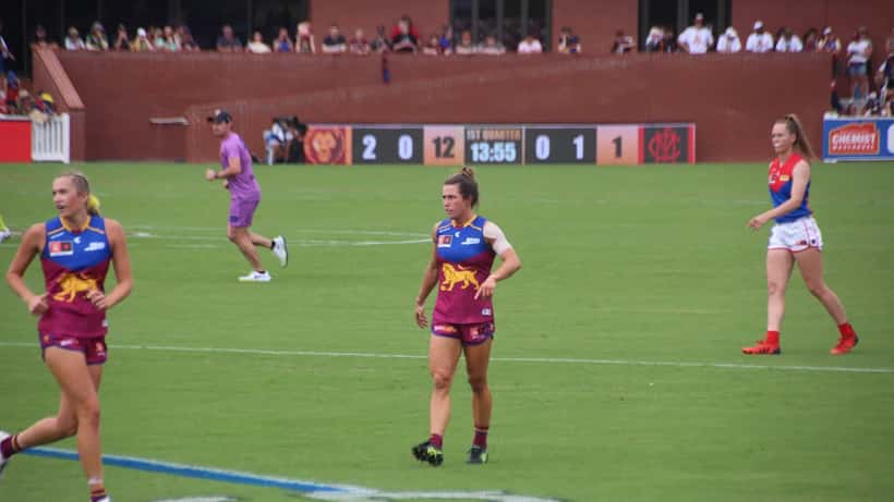 AFLW player in action during the 2026 season, Australian women's football match at night