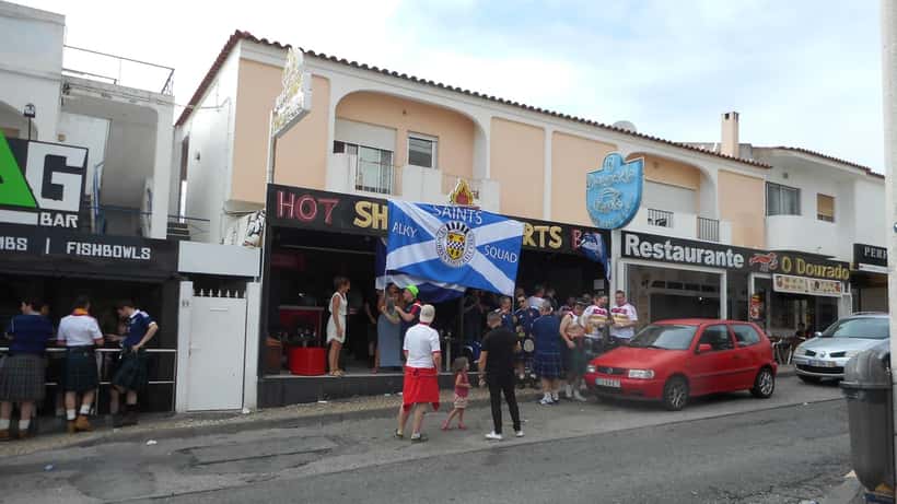 Scotland Tartan Army fans in kilts cheering at a football match World Cup qualifier