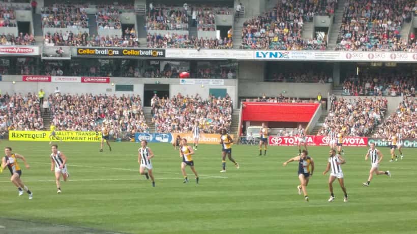 AFL players competing in a match at an Australian football stadium