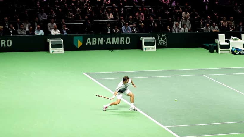 Stan Wawrinka playing a groundstroke on a tennis court