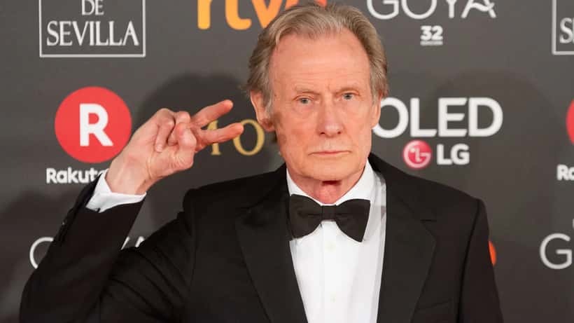 Bill Nighy at the 2018 Goya Awards ceremony, smiling confidently in a suit