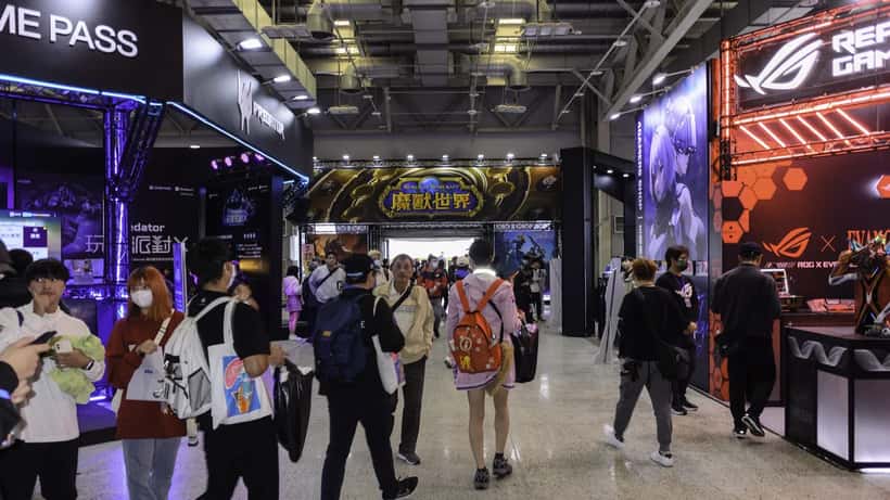 World of Warcraft gaming expo display with WoW advertisement banner at trade show booth