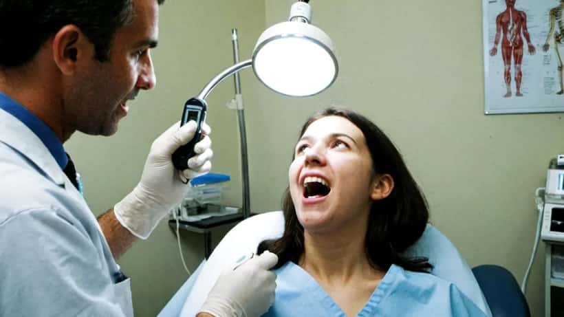 Doctor or dentist performing an oral examination in a modern Australian clinic